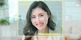 Smiling woman with emotion detection AI showing her as happy.